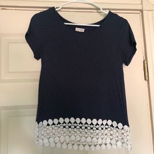 Navy blue top with white polka dot pattern